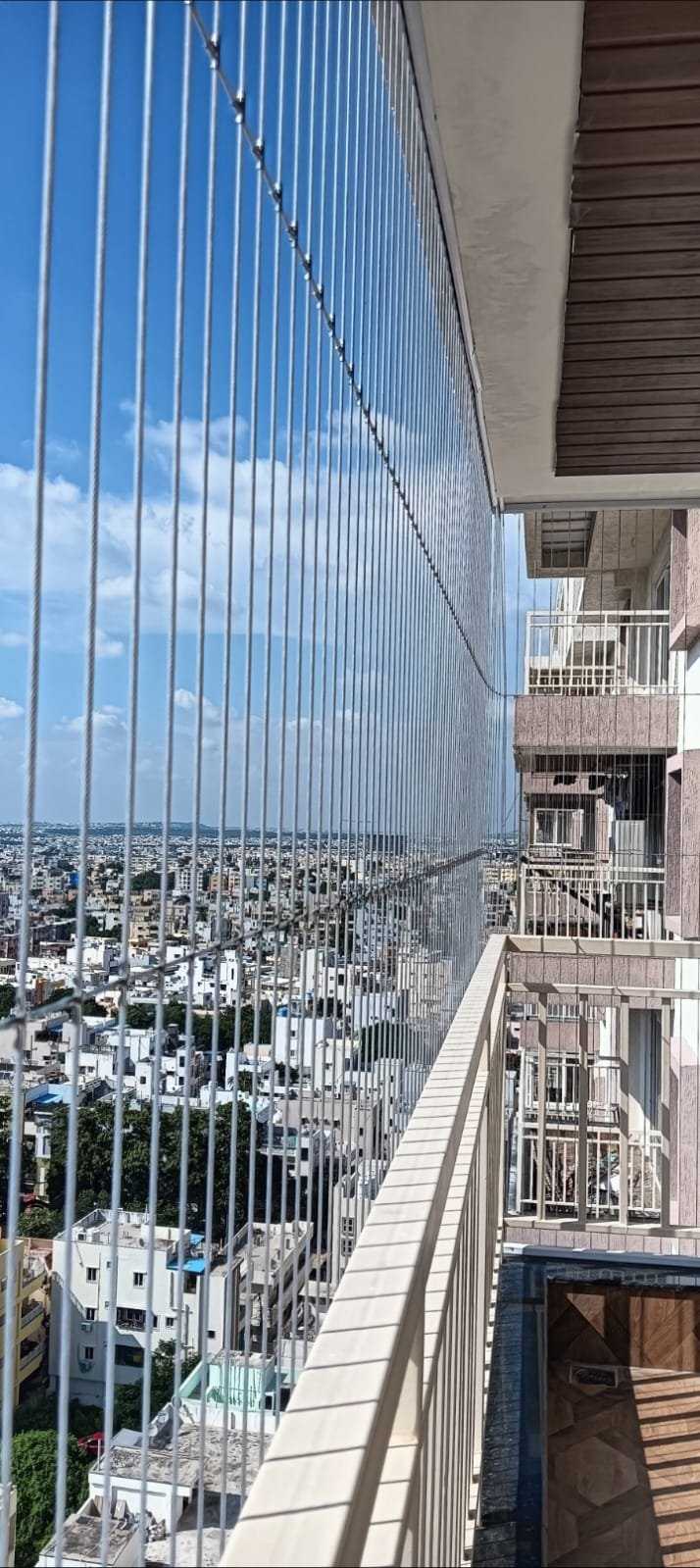 High-rise balcony safety net with a clear city view