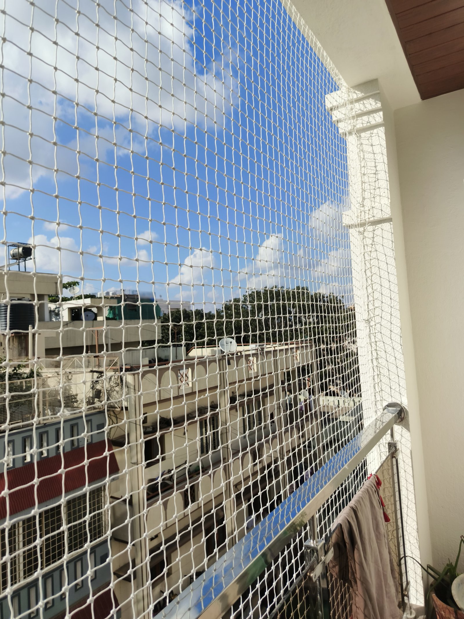 White balcony safety net tensioned from floor to ceiling