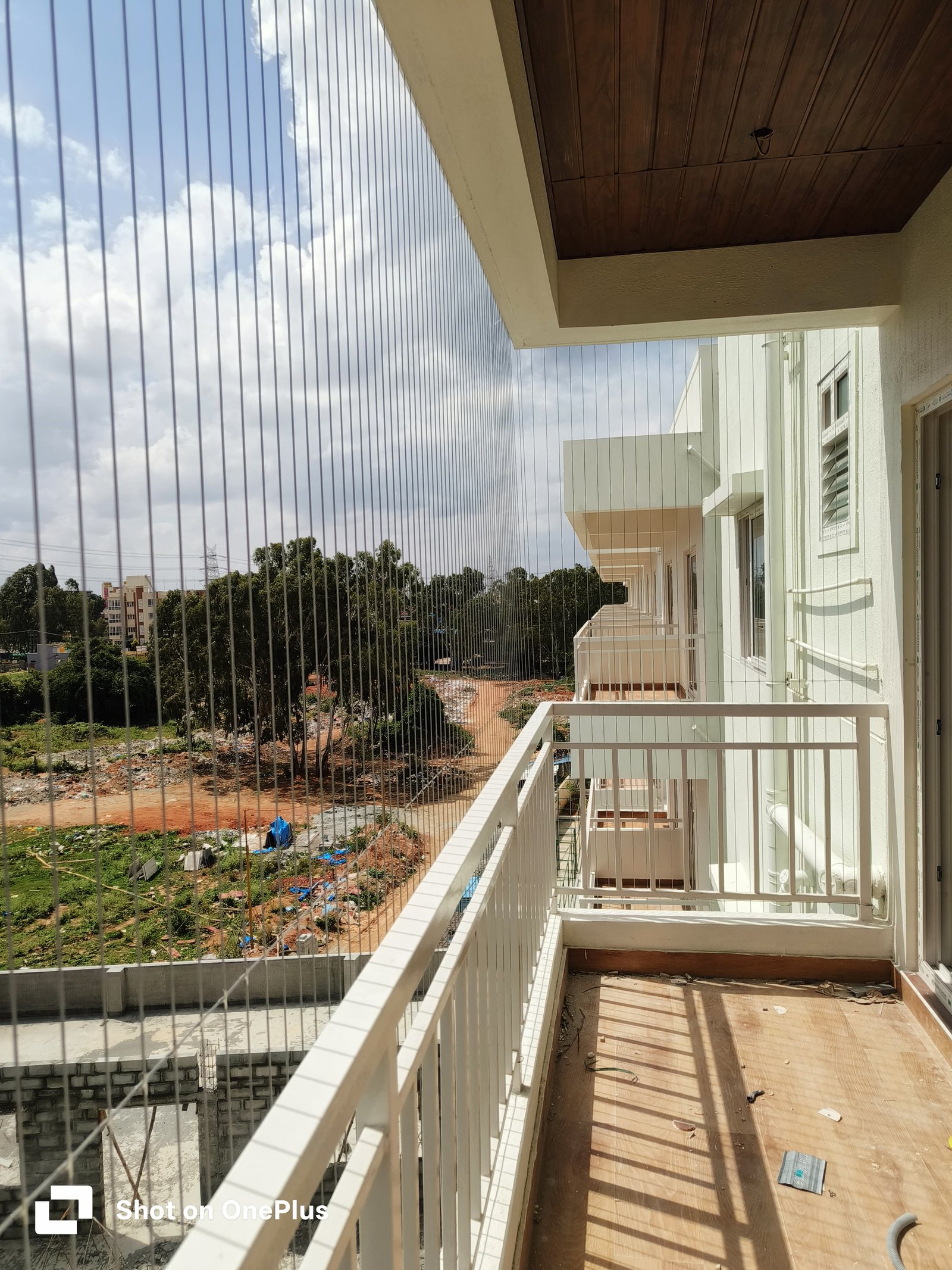 A real completed invisible grill installation in a bright apartment balcony
